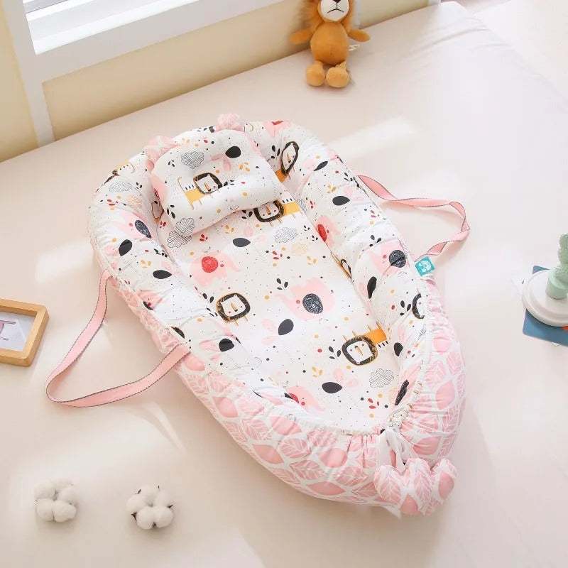réducteur de lit bébé rose