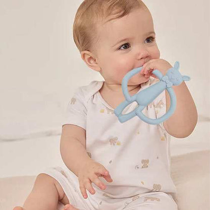Anneau de dentition bleu dans la bouche de bébé 