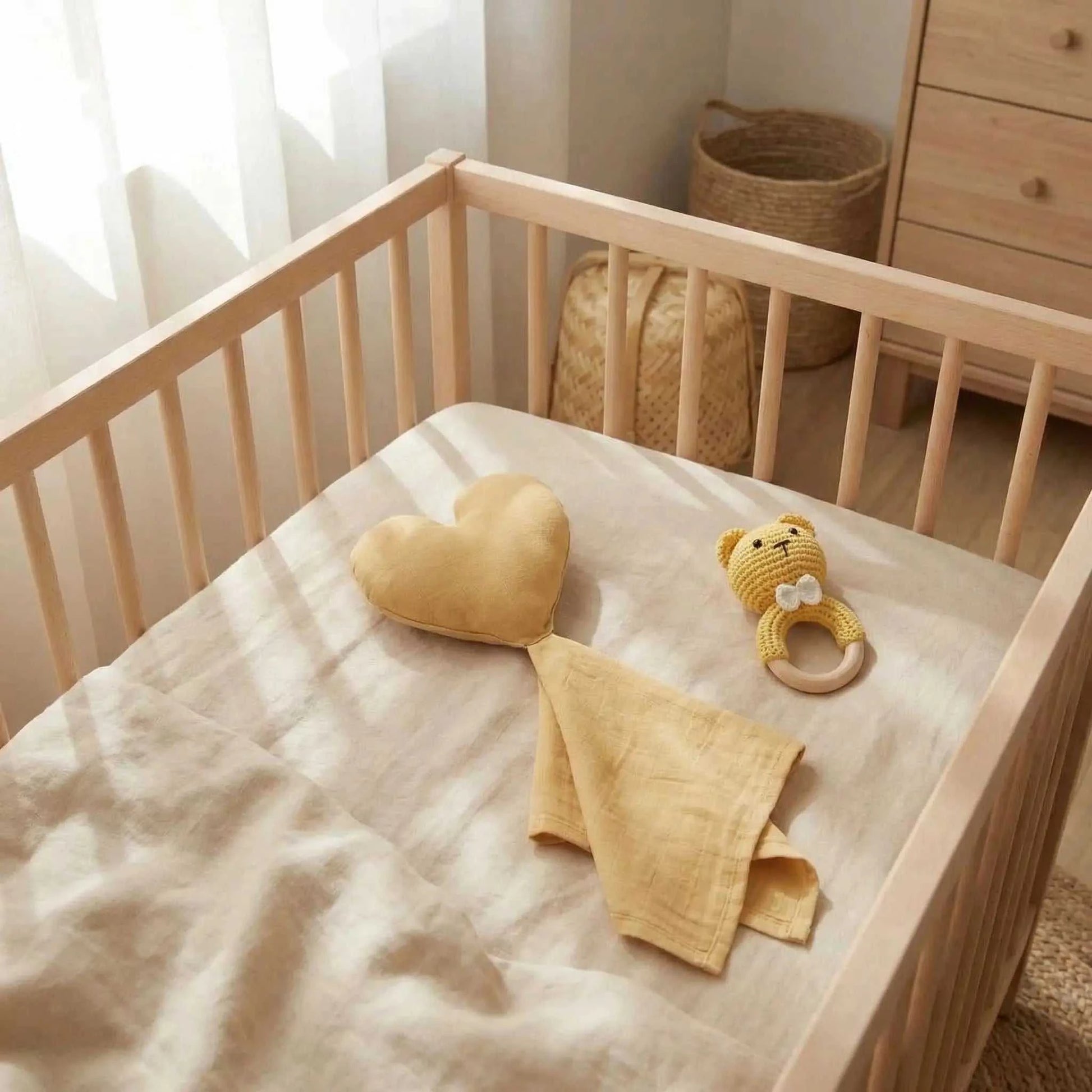 doudou en forme de cœur moutarde-sur le lit de bébé