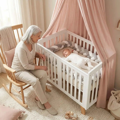 mamie a coté de bébé endormi dans son lit entouré d'un tour de lit tresse ultra-doux et protecteur